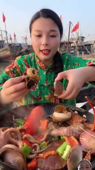 Female Fisherman Is Eating King Crab Prawns Conch Lobster Octopus