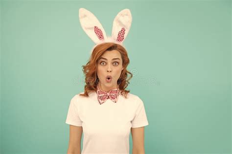 Surprised Easter Woman With Bunny Ears On Blue Background Stock Photo