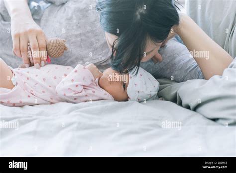 Mom With Pleasure Sniffing Her Newborn Baby Stock Photo Alamy
