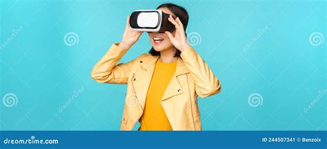 Portrait Of Happy Asian Female Model Using Vr Headset Smiling And