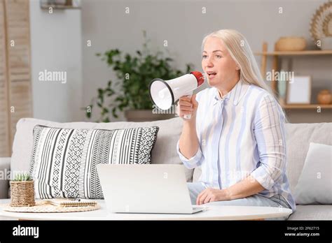 Screaming Mature Woman With Megaphone At Home Stock Photo Alamy