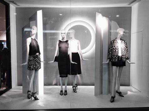 Three Mannequins Dressed In Black And White Outfits