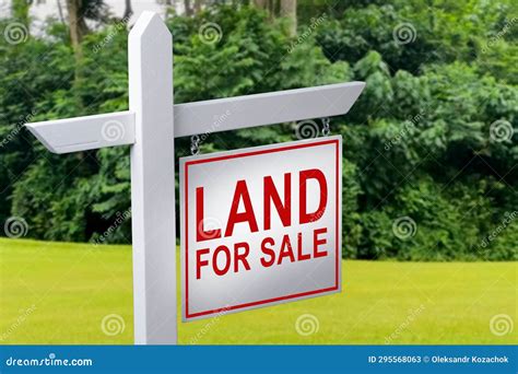 Land For Sale Sign On Empty Meadow Real Estate Conceptual Image