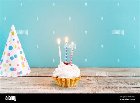 Celebratory Cupcake With Candles On A Blue Background Decorations For