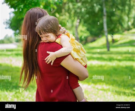 Mother Holding Her Crying One Year Old Baby Girl With Tears Close Up