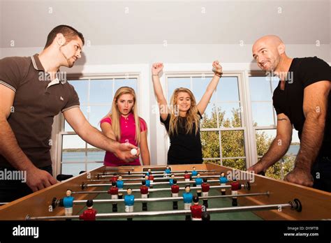 Two Gay Fathers Enjoy Some Fun Recreational Time With Their Daughters At A Vacation Home Stock