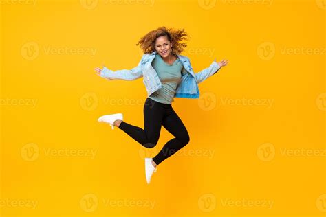 Happy Energetic Smiling Young African American Woman Jumping Isolated