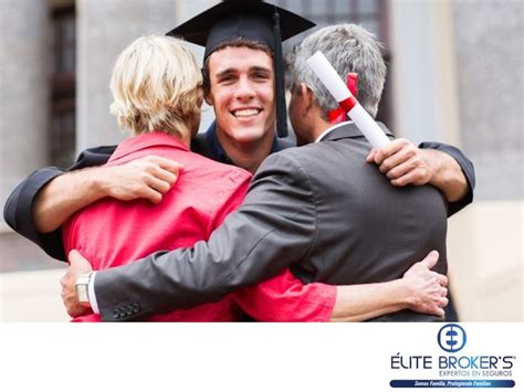 Two Men Hugging Each Other In Front Of A Building Wearing Graduation