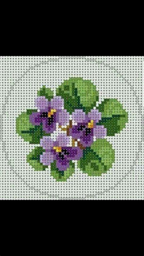 A Cross Stitch Pattern With Purple Flowers On It