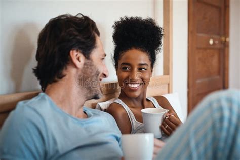 Happy Hug Interracial Couple And Portrait On A Sofa At Home With Love And Care In A Living Room