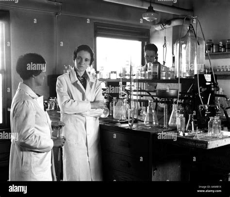 1930s Two Women One Man Wearing Long White Lab Coats Standing Next To