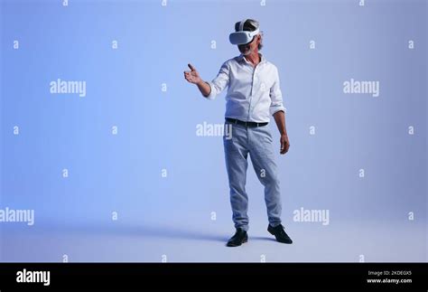 Mature Businessman Giving A Virtual Handshake In A Studio Senior
