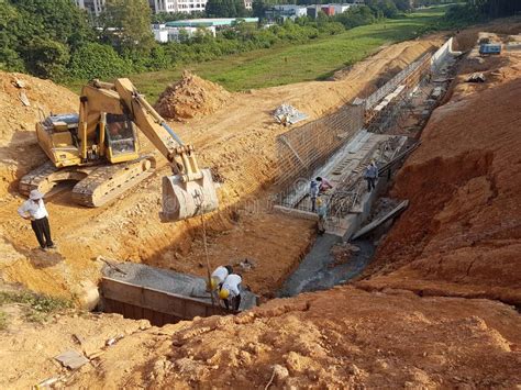 Heavy Machinery Doing Earthwork At The Construction Site Editorial