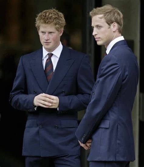 two men in suits standing next to each other