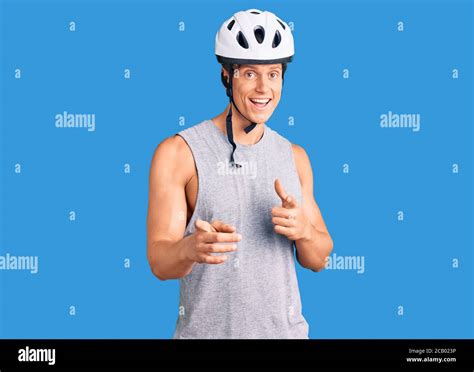 Young Handsome Man Wearing Bike Helmet Pointing Fingers To Camera With