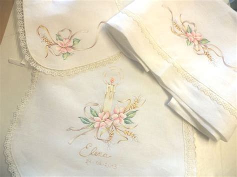 Two White Handkerchiefs With Pink Flowers On Them And A Candle