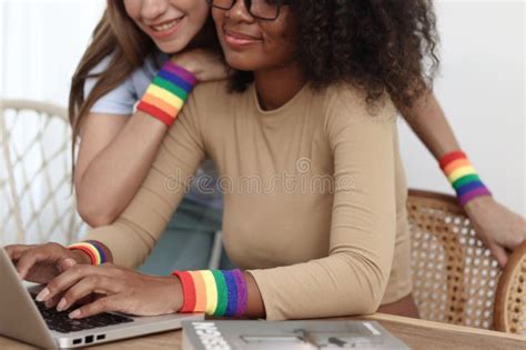 Happy Smiling Homosexual Lesbian Couple With Rainbow Flag Wristband