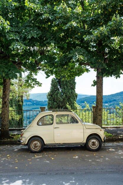 Premium Photo Vintage Car Parked On Road By Trees