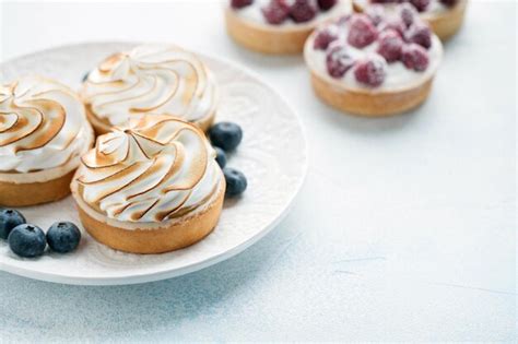 Premium Photo Delicious Lemon And Raspberry Tartlets With Meringue On