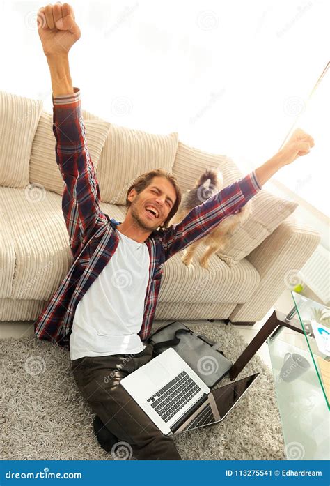 Happy Guy With Laptop Jubilant In Spacious Living Room Stock Image