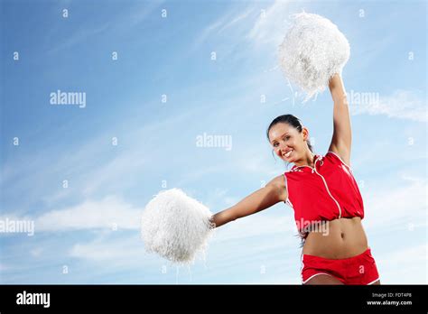 Young beautiful female cheerleader in uniform jumping high Stock Photo ...