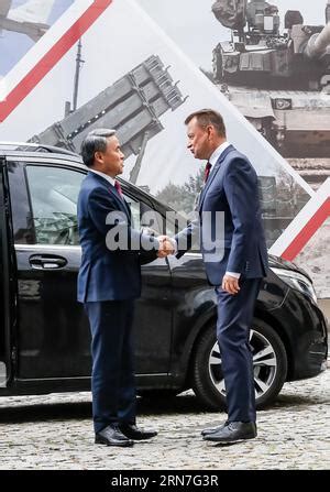 Polish And Korean National Flags Wave As Mariusz B Aszczak Minister Of