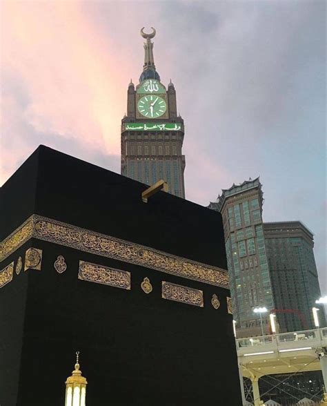 A Large Black Building With A Clock On It S Side In Front Of Some Tall