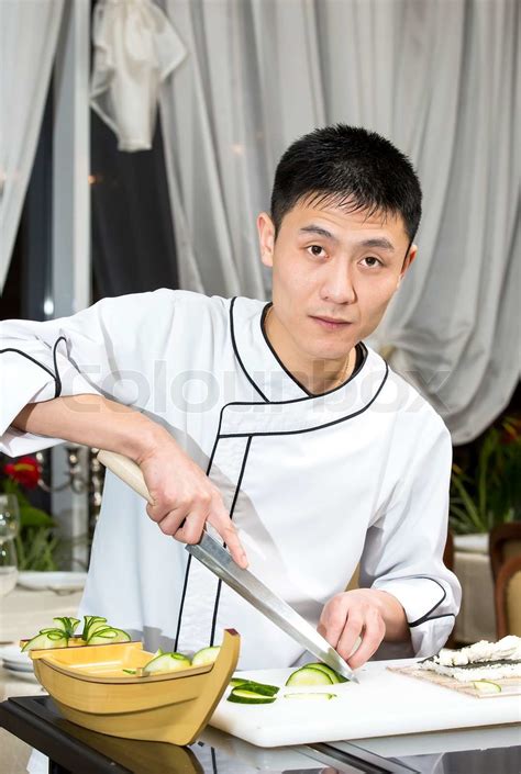 Japanese chef preparing a meal in a restaurant | Stock image | Colourbox