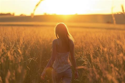 Premium Photo Woman Walking Through Tall Grass