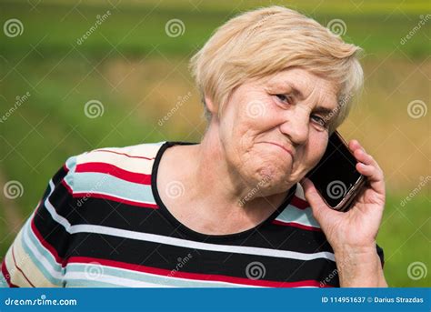 Mature Woman Talking On A Phone Having Some Doubts Look Stock Image