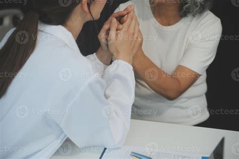 African female doctor hold hand of caucasian woman patient give comfort