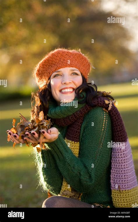 Brunette Girl Collecting Autumn Leaves Stock Photo Alamy