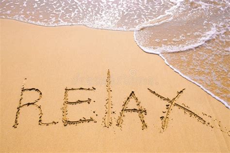 Word Relax Hand Written In The Sand With A Sea Wave Close Up Sand