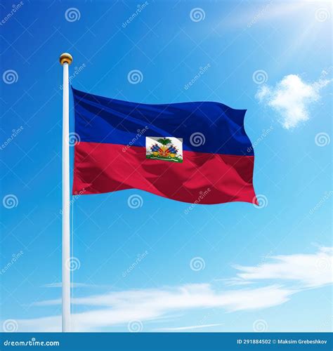 Waving Flag Of Haiti On Flagpole With Sky Background Stock Photo