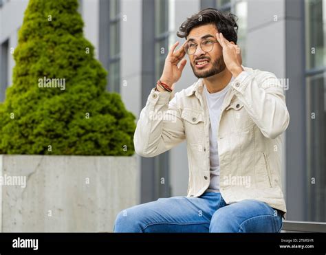 Displeased Sick Ill Indian Man Rubbing Temples To Cure Headache Problem