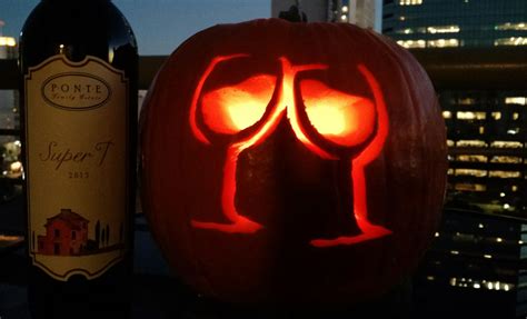 A Pumpkin Carved To Look Like Two Glasses And A Bottle Of Wine Is Next To It