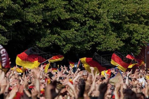 Detail Of People In A Crowd Waving German Flags Stock Photo Dissolve