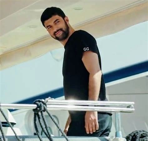 A Man Standing On The Deck Of A Boat