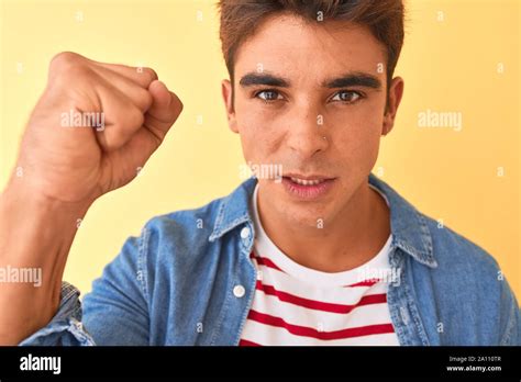 Young Handsome Man Wearing Striped T Shirt And Denim Shirt Over