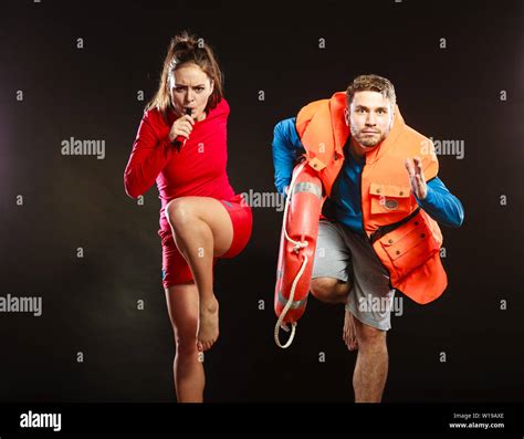 Lifeguards With Rescue Ring Buoy Lifebuoy And Life Vest Jacket Running