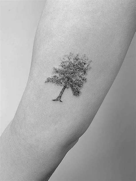 A Small Tree Tattoo On The Left Inner Arm