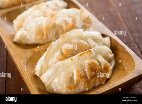 Close Up Fresh Pan Fried Dumplings On Plate With Hot Steams Asian Dish