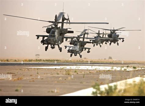 A Group Of Ah 64d Apache Helicopters Landing On The Runway Stock Photo