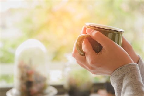 Premium Photo Woman Hands Holding Hot Cup Of Coffee Or Tea In Morning