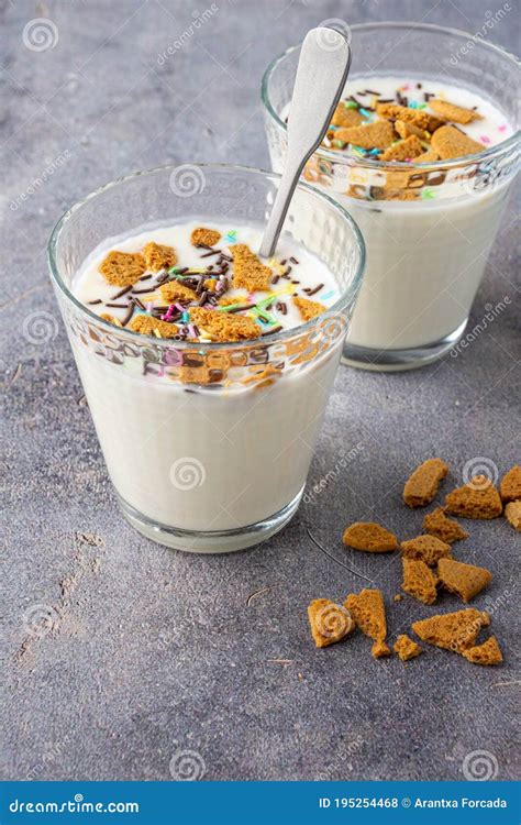 Close Up Of Two Glasses With Natural Yogurt Biscuit Pieces And Colors