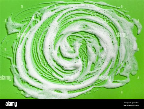 Foam Soap Suds On Green Background Laundry Cleaning Washing Concept