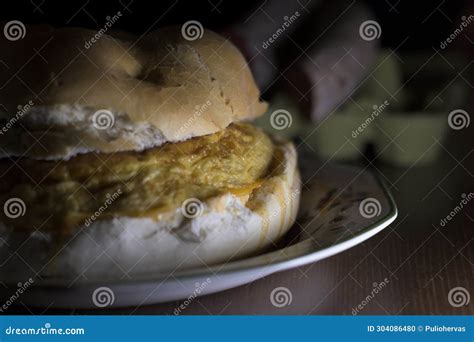 Detail Of Potato Omelet Sandwich With Round Artisan Bread And Glass Of