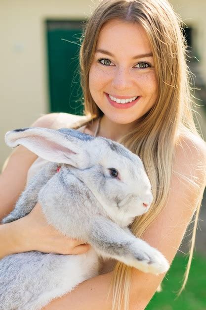 Premium Photo Beautiful Young Woman With Bunny Rabbit On Farm