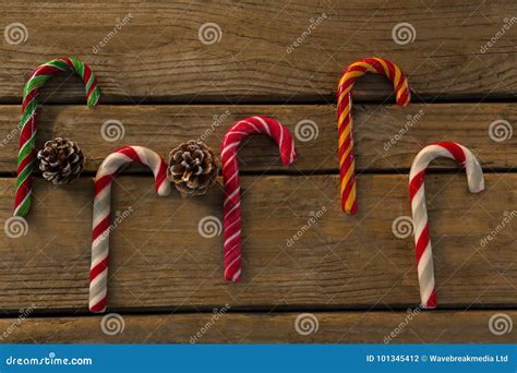 Overhead View Of Colorful Candy Canes With Pine Cones Stock Photo