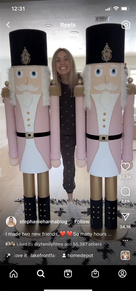 A Woman Standing Next To Two Giant Nutcrackers